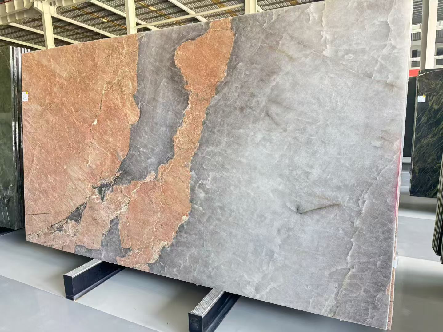 Pink Patagonia Quartzite slab featuring dramatic warm pink crystalline formations, expansive silver-grey areas and irregular natural mineral patterns. Pink Patagonia Quartzite slab featuring dramatic warm pink crystalline formations, expansive silver-grey areas and irregular natural mineral patterns.